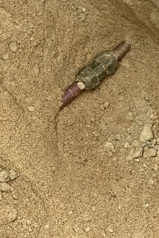 A water line buried in the ground.