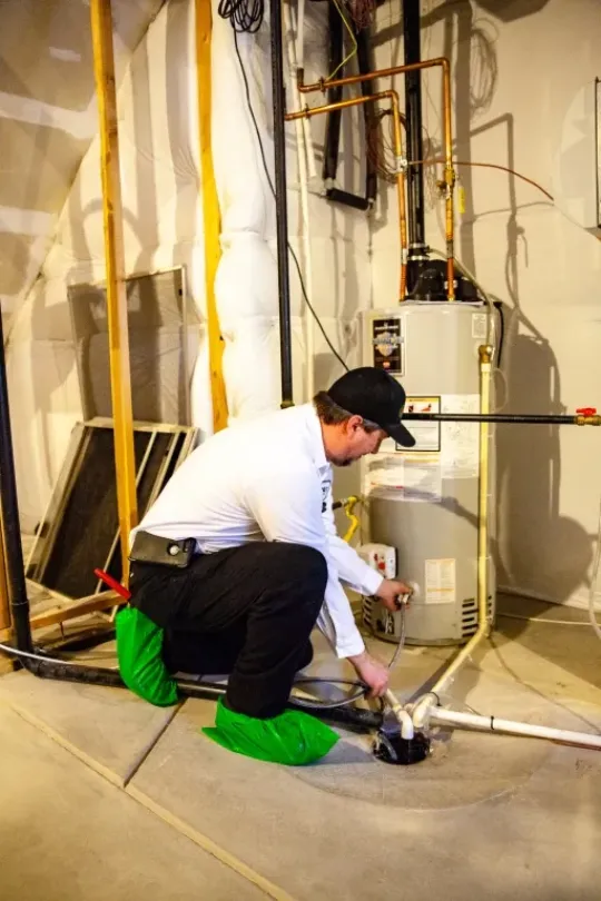 A technician working on a water heater flush