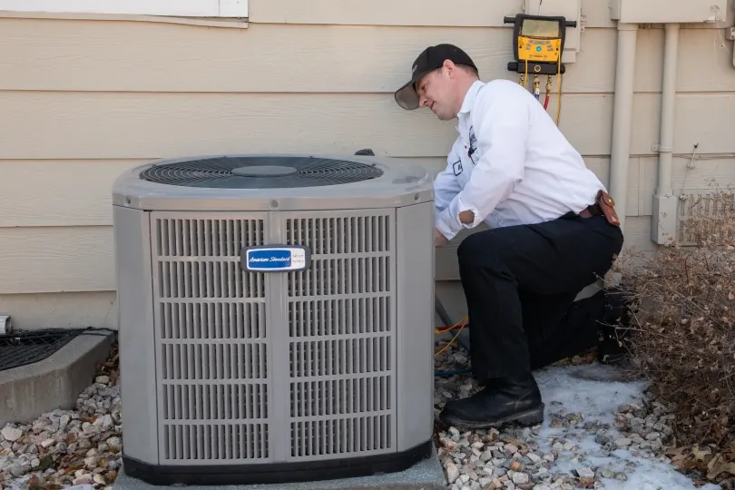 A technician working on an AC unit.