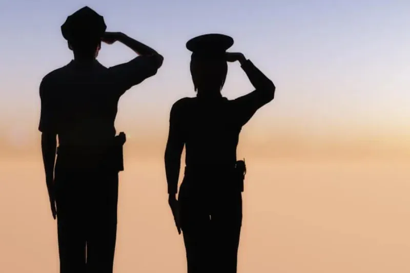 Military people saluting.
