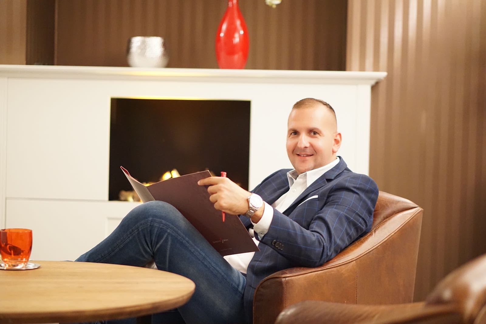 Nikola Virijević reviewing a contract with pen in hand at his office in Hamburg