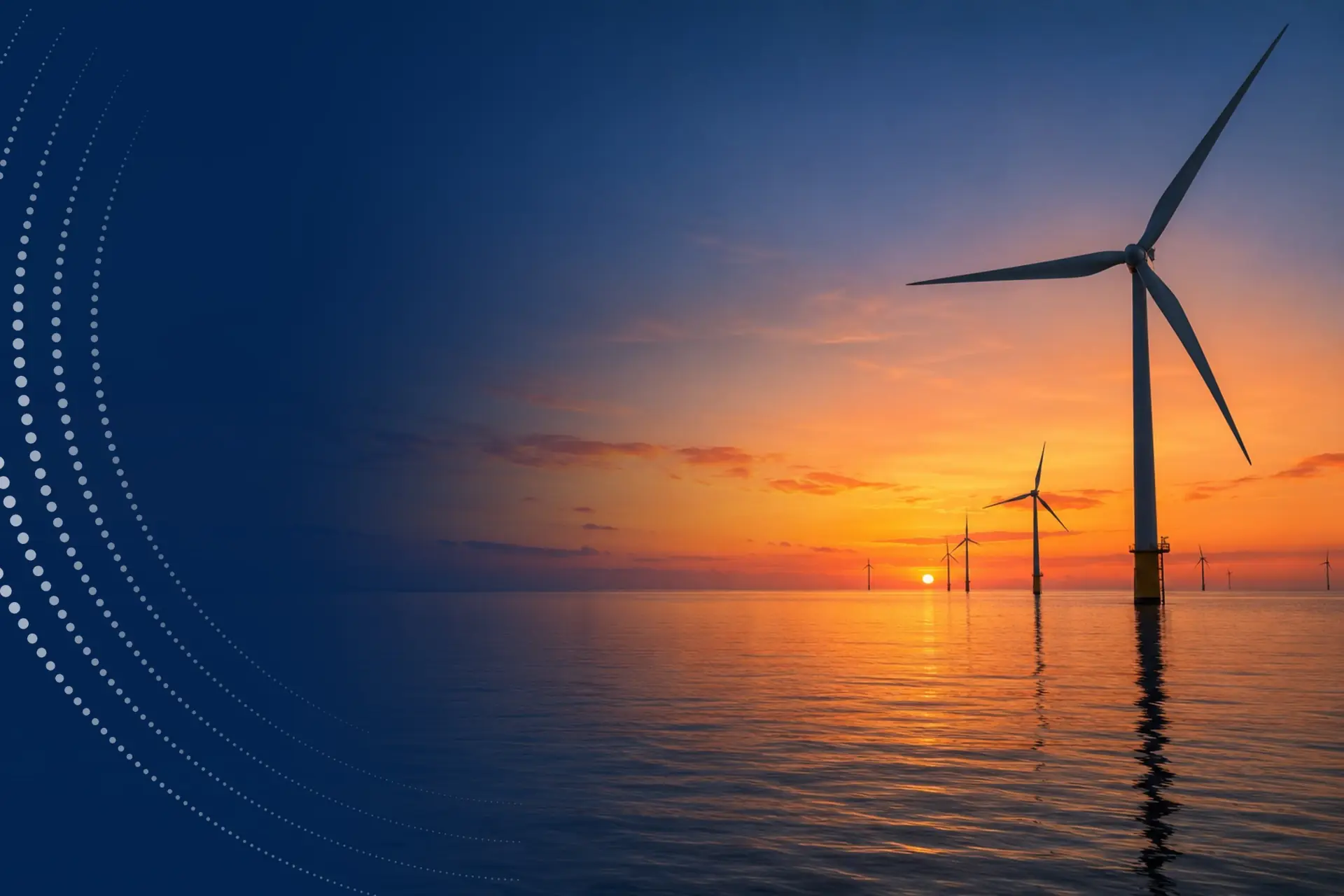 Offshore wind turbines at sunset over a calm sea.