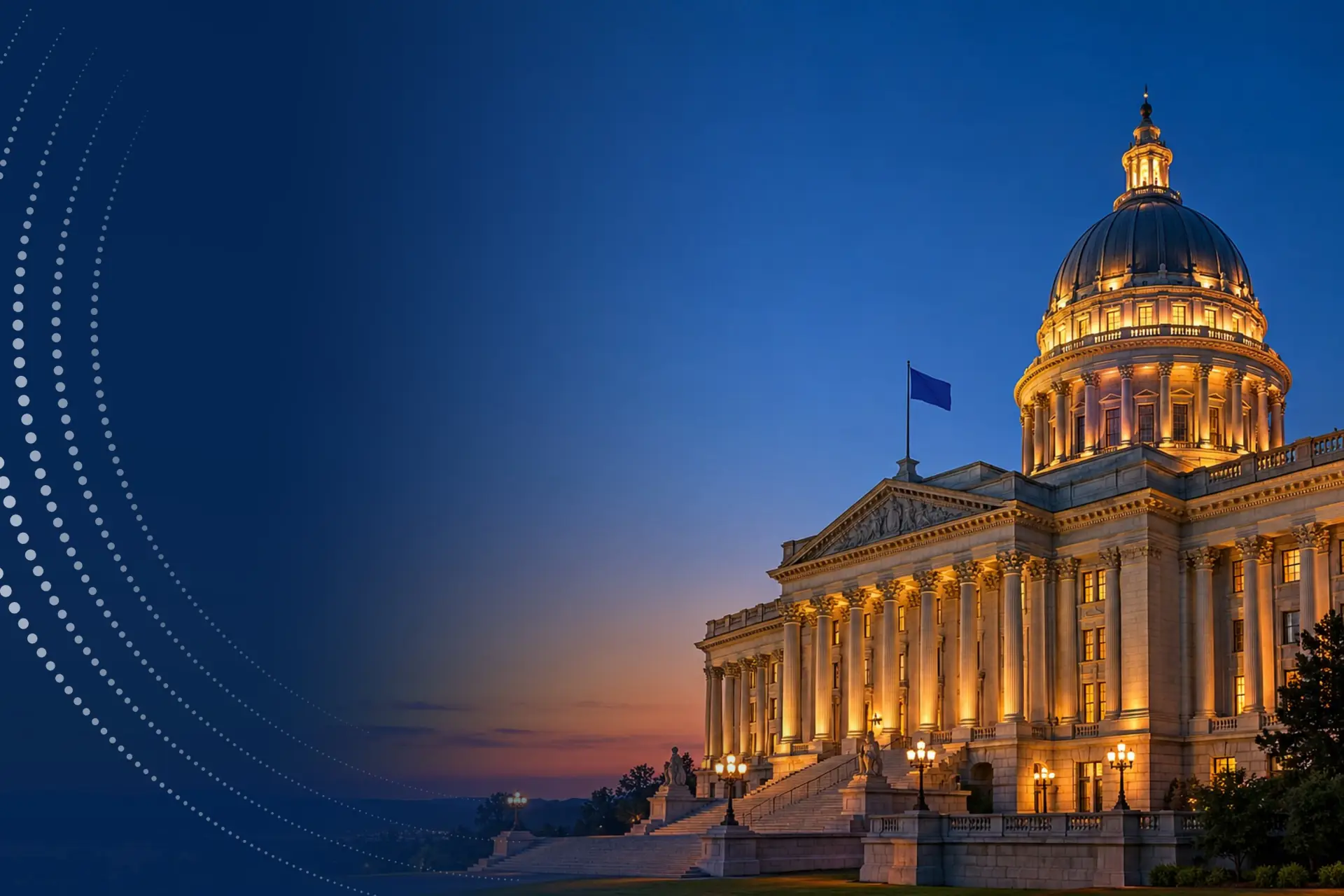 A floodlit, domed government building with a colonnade at dusk.