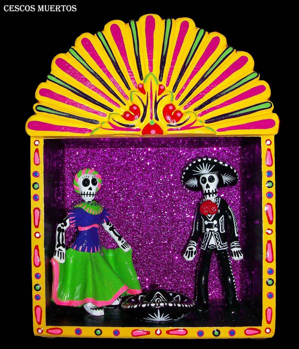 A bright folk-art shadow box with a Catrina and Catrin pair