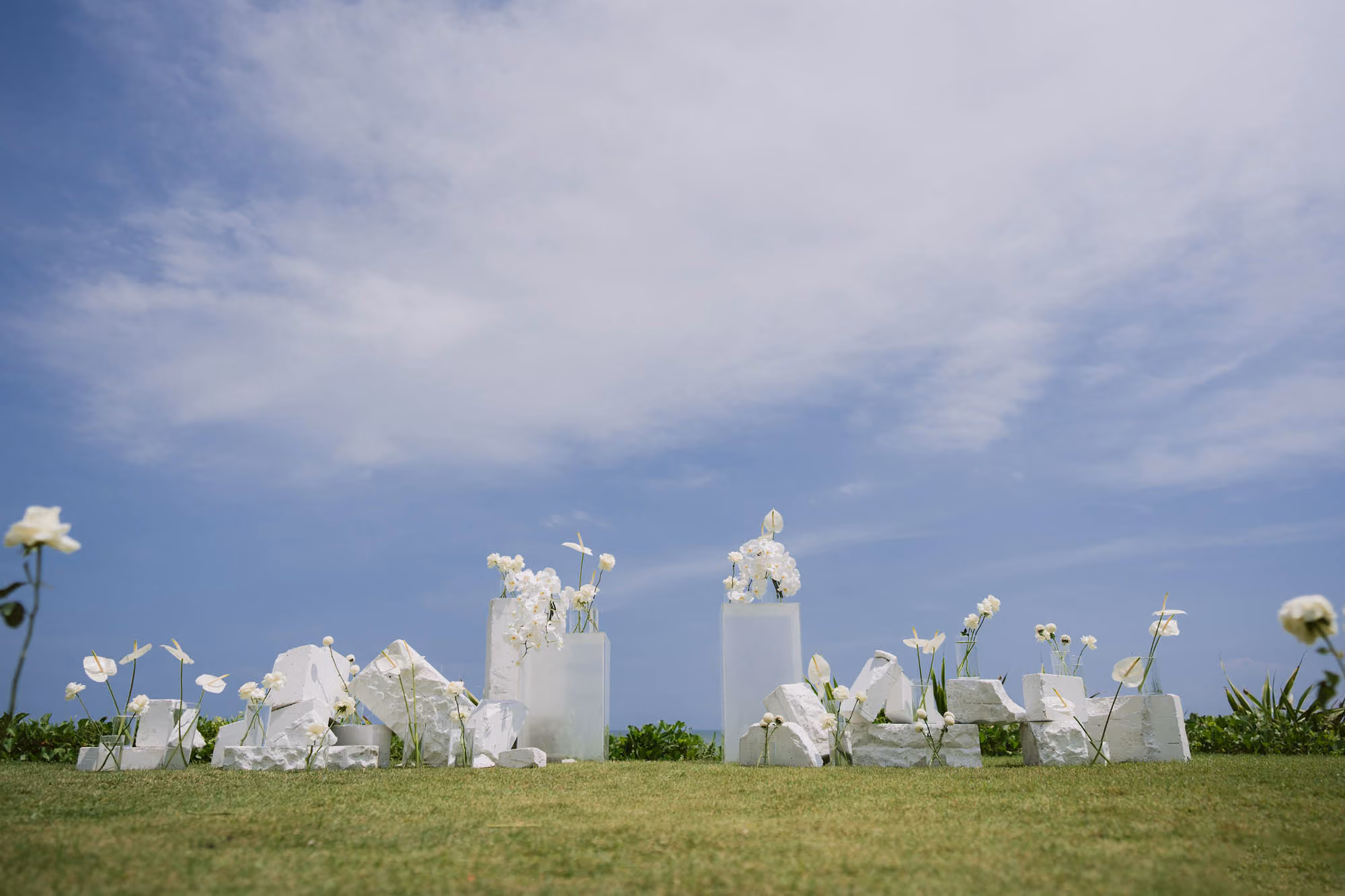 Frosted glass floral vase decor arranged on the lawn under a blue sky