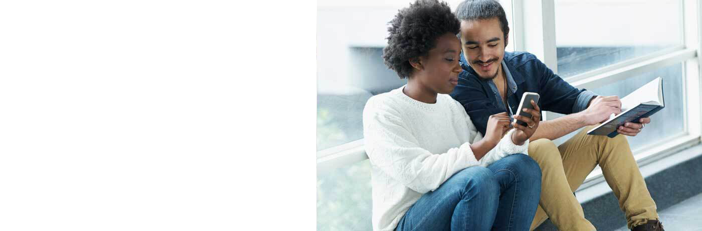 Two university students looking at a cellular device