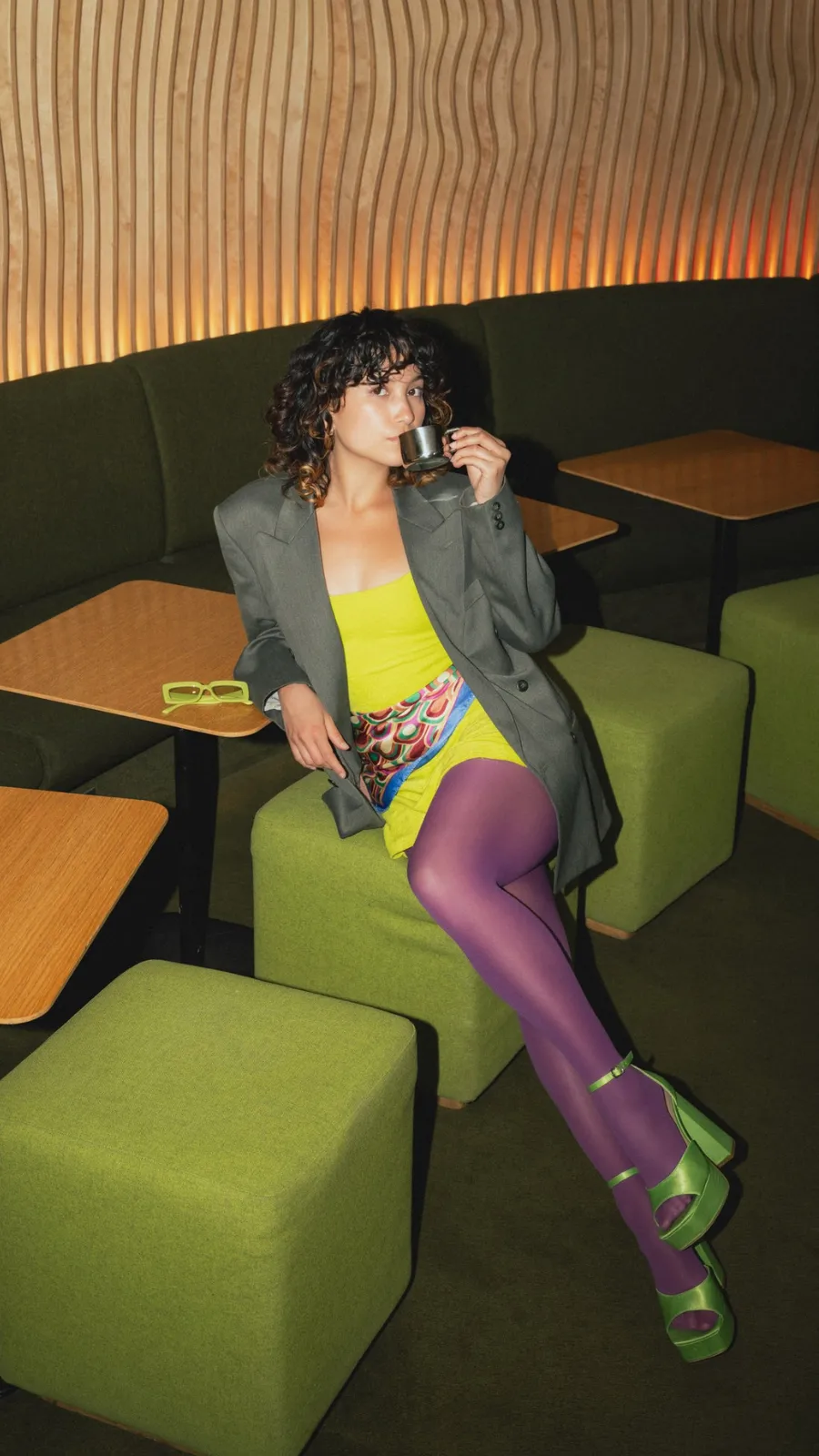 Woman drinking coffee in the Green Room, early morning at the ORA-ÏTO design hotel, Paris 1st arrondissement