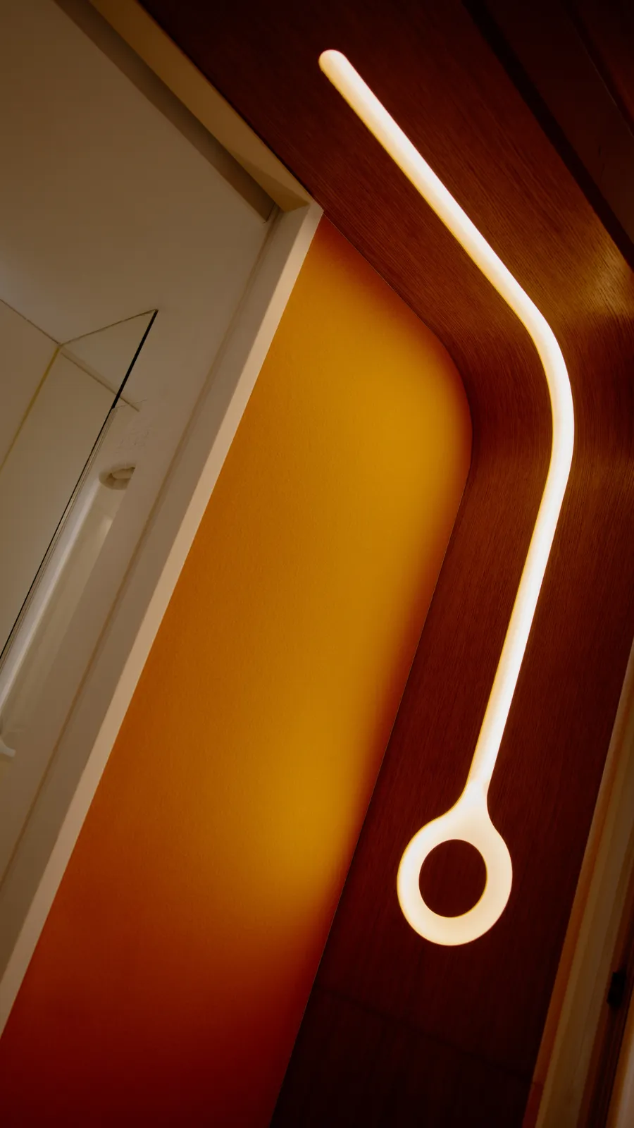 Ring light fixture on an orange wall, ORA-ÏTO design hotel in Paris 1st arrondissement