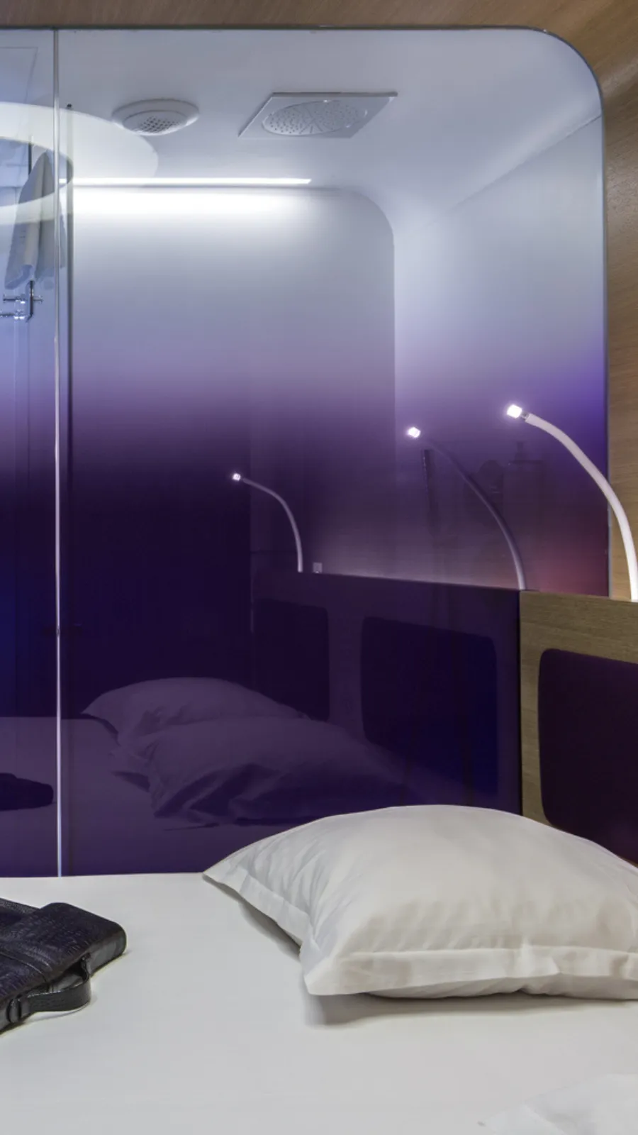 Bed facing the purple glass wall, room at the ORA-ÏTO design hotel, Paris 1st arrondissement