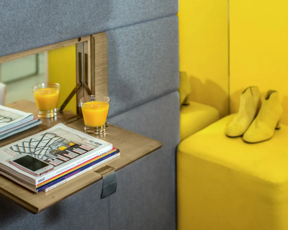 Tablette avec jus d'orange et pouf jaune, chambre Cocoon, hôtel capsule Paris 1er