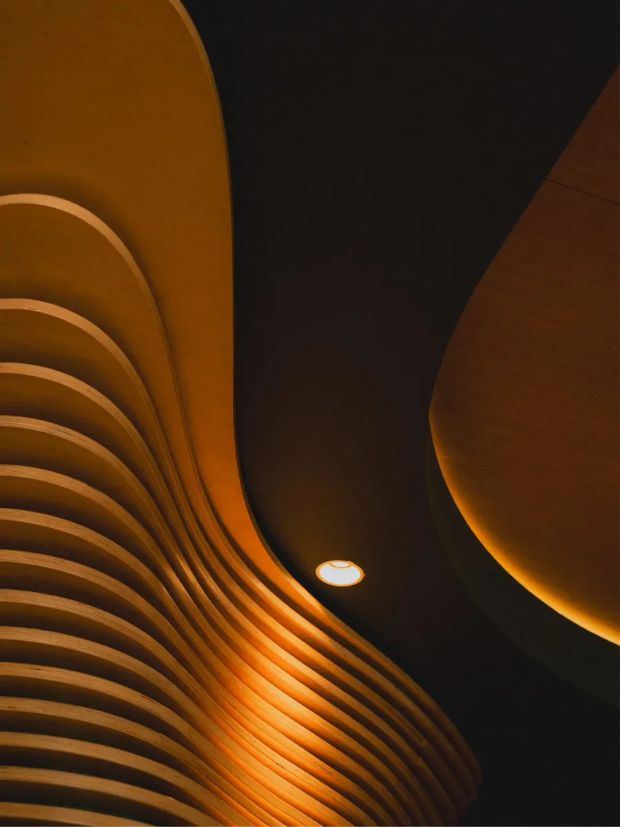Copper-toned wooden slat curves, signature of the ORA-ÏTO design hotel, Paris 1st arrondissement