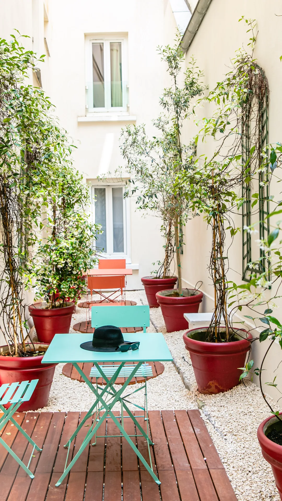 Flowered patio and turquoise bistro tables, design boutique hotel in Paris 1st arrondissement