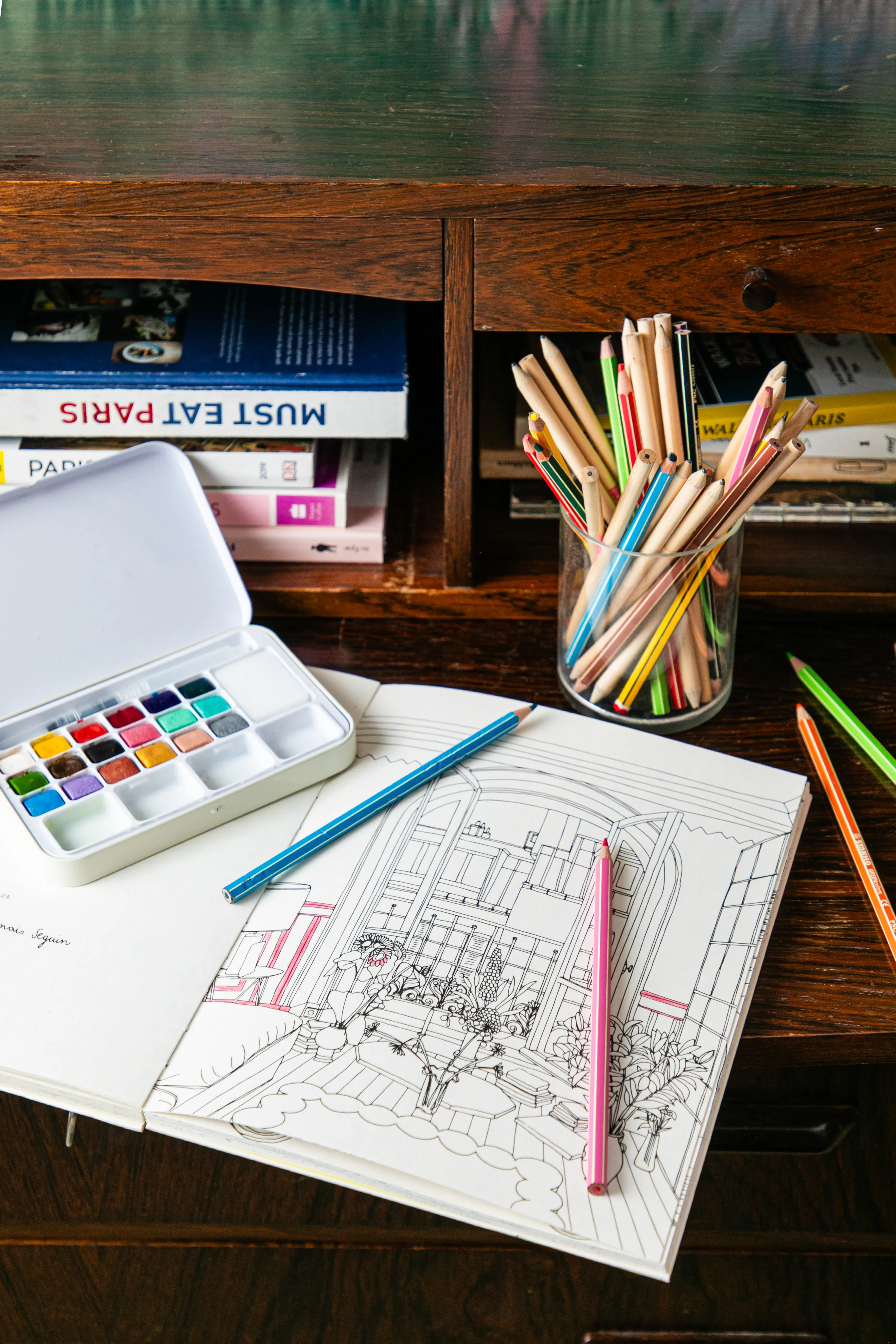 Paris coloring book, pencils, and watercolors on an antique secretary desk at Hôtel Crayon, Paris 1st arrondissement