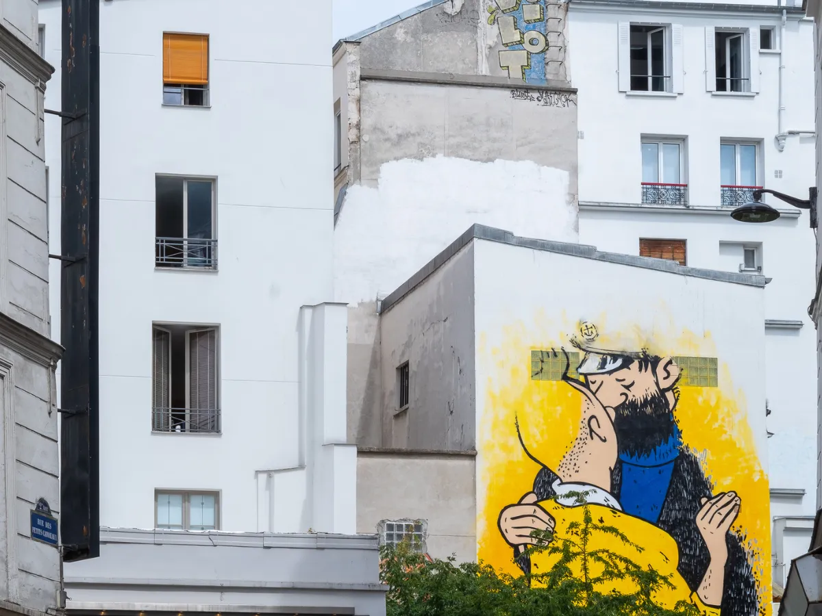 Mural of Tintin and Captain Haddock on a building facade in central Paris, just a short walk from Hôtel Crayon