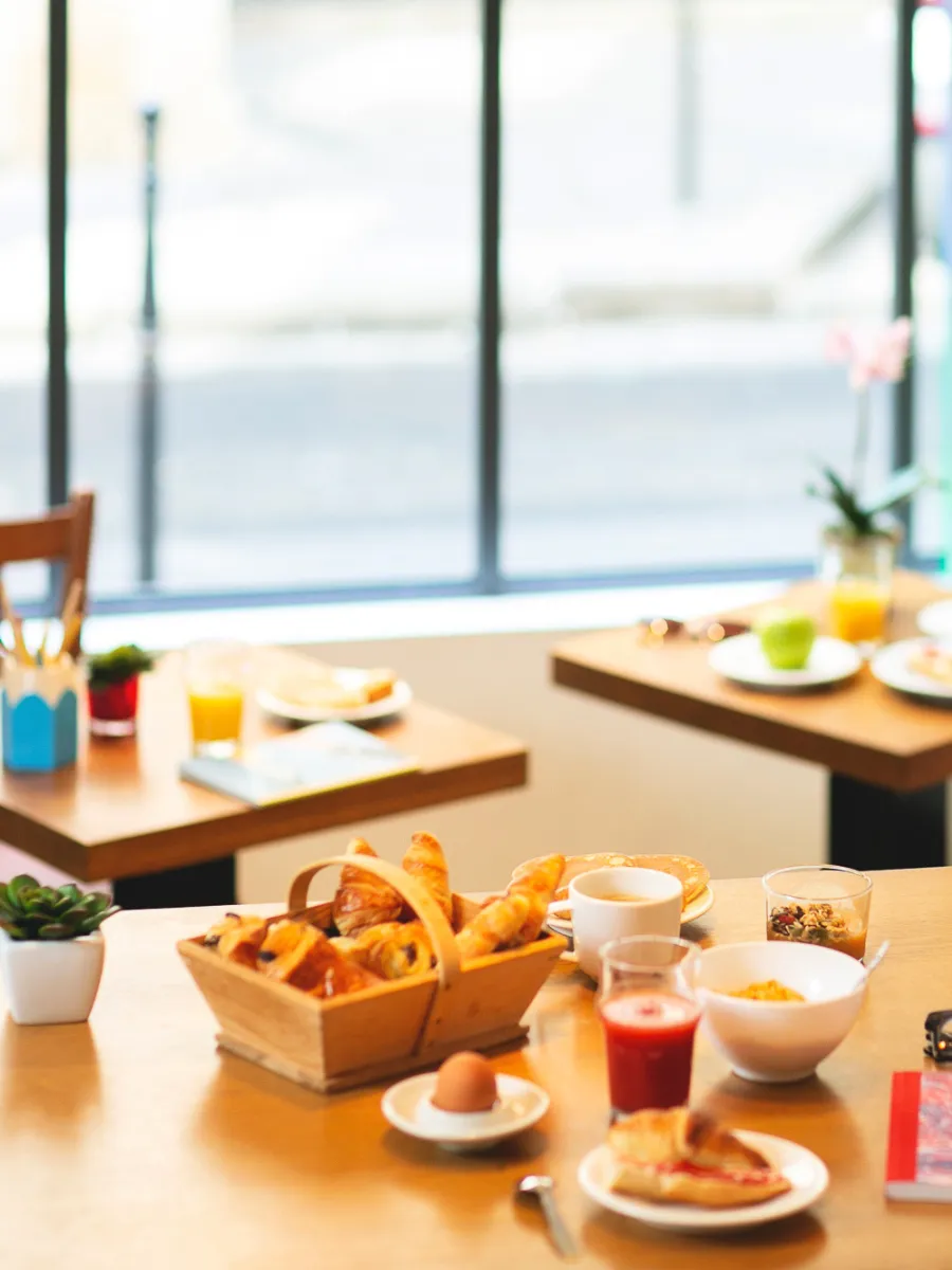 Breakfast buffet with pastries and fruit juices in the dining room of the Hôtel Crayon in Paris 1st arrondissement