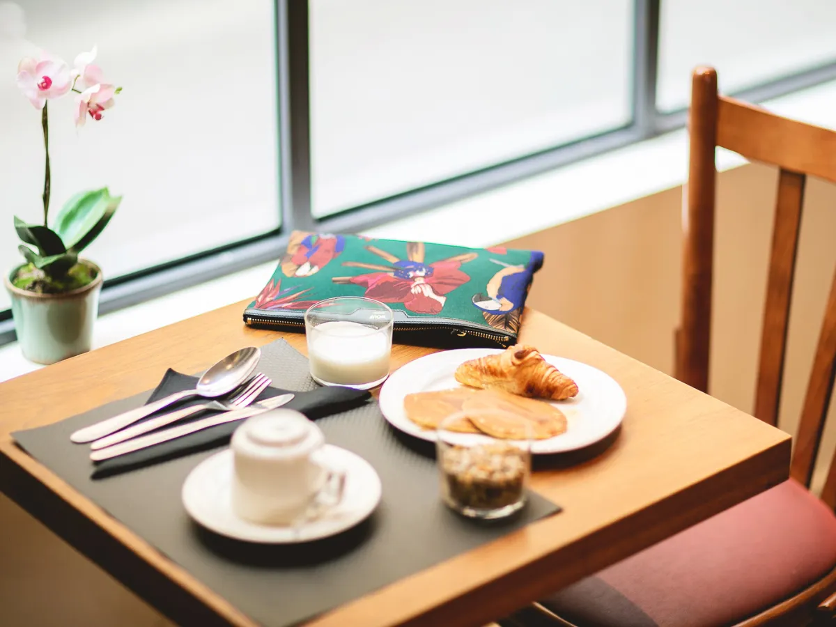 Breakfast at a table by the bay window in the common room of Hôtel Crayon, Paris 1st arrondissement