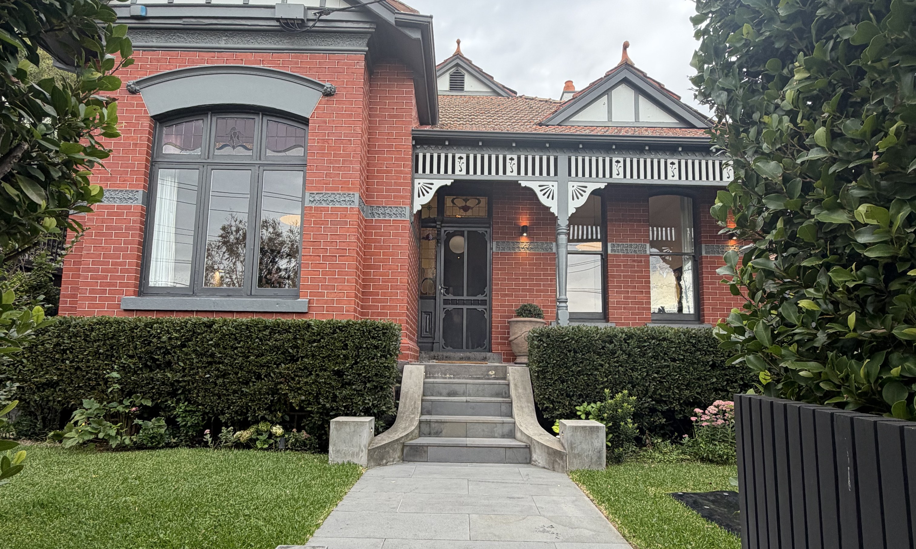 Red brick period home with a formal front path and hedging