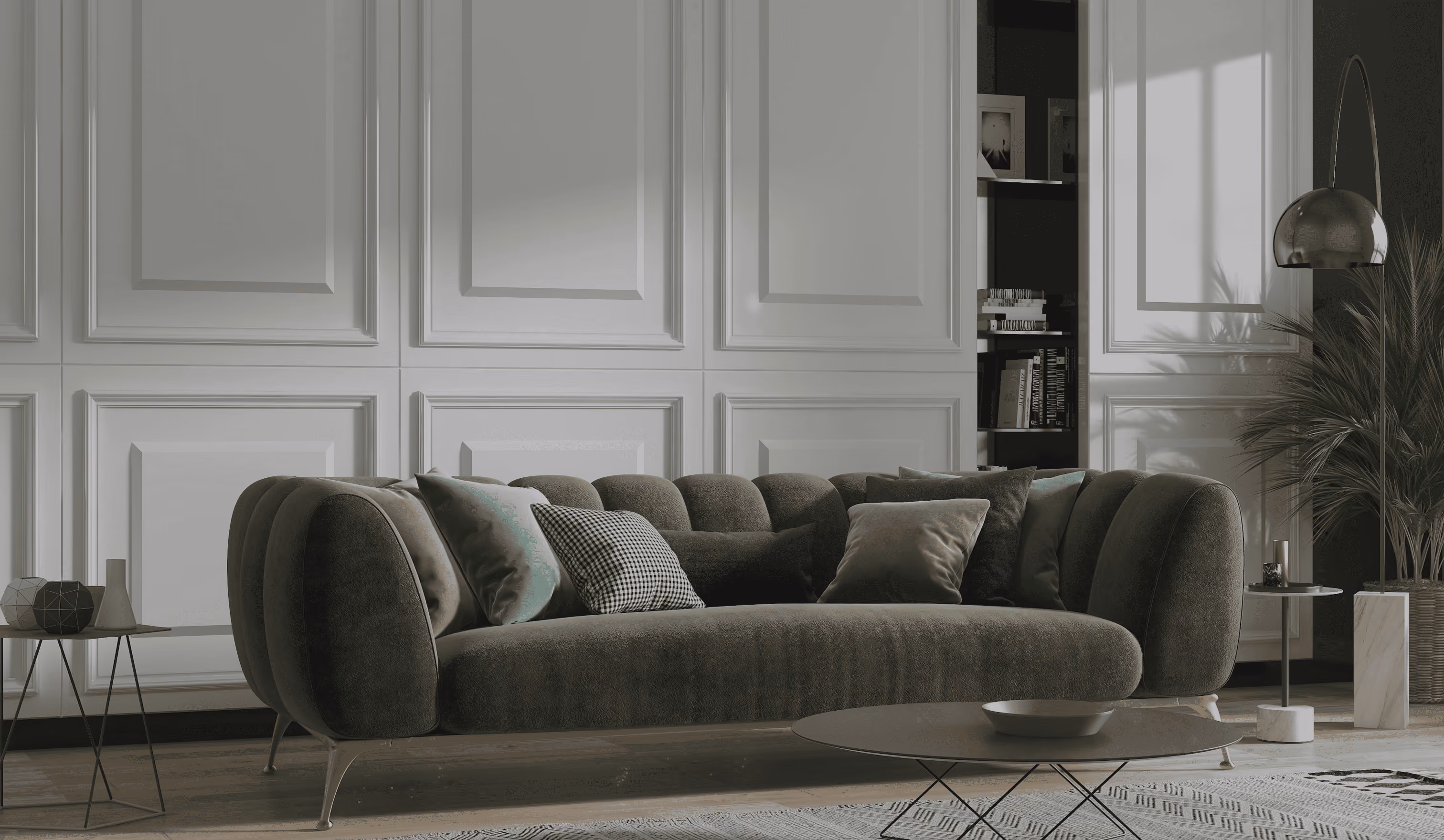 Modern living room with dark gray curved sofa, multiple pillows, round coffee table, and tall floor lamp.