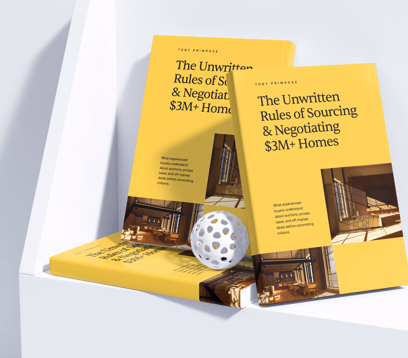 Three yellow books titled 'The Unwritten Rules of Sourcing & Negotiating $3M+ Homes' on a white shelf.