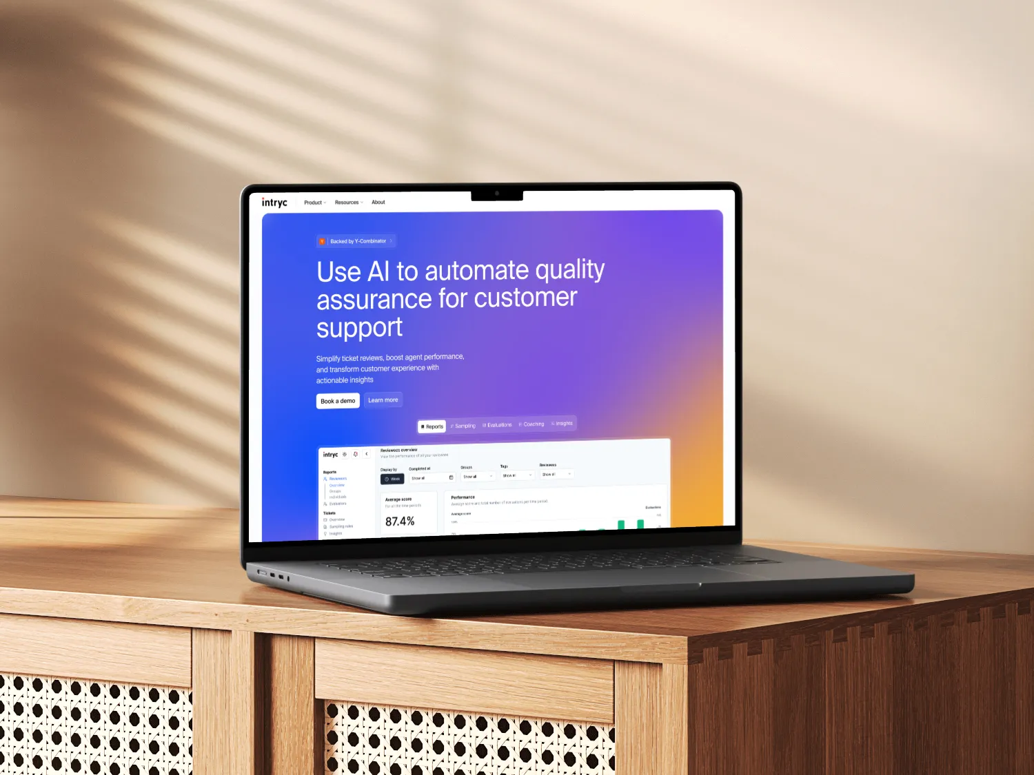 MacBook Air on wooden surface displaying a website with AI-powered customer support quality assurance interface.