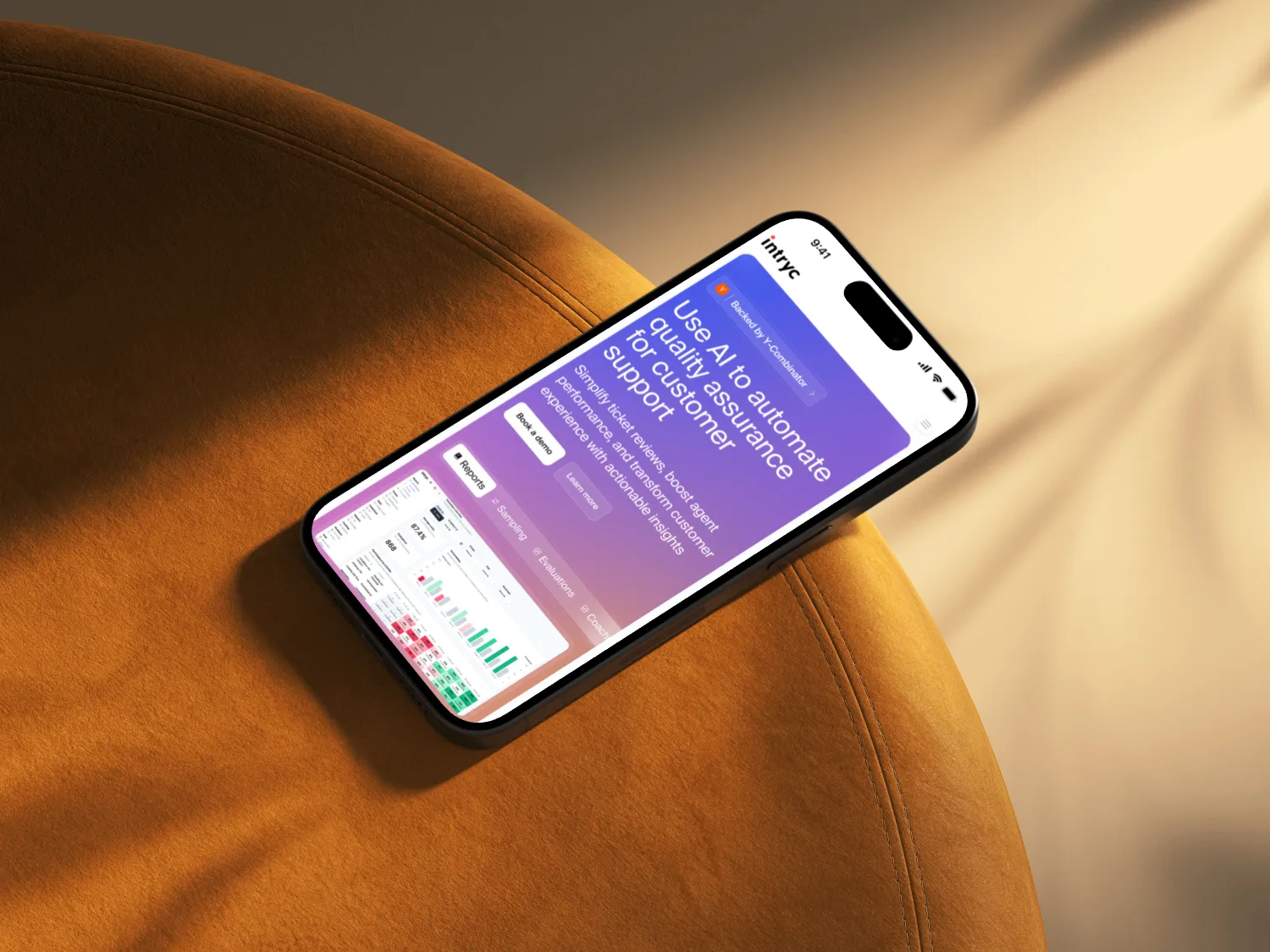 Smartphone displaying a webpage about using AI to automate quality assurance for customer support, placed on an orange textured surface.