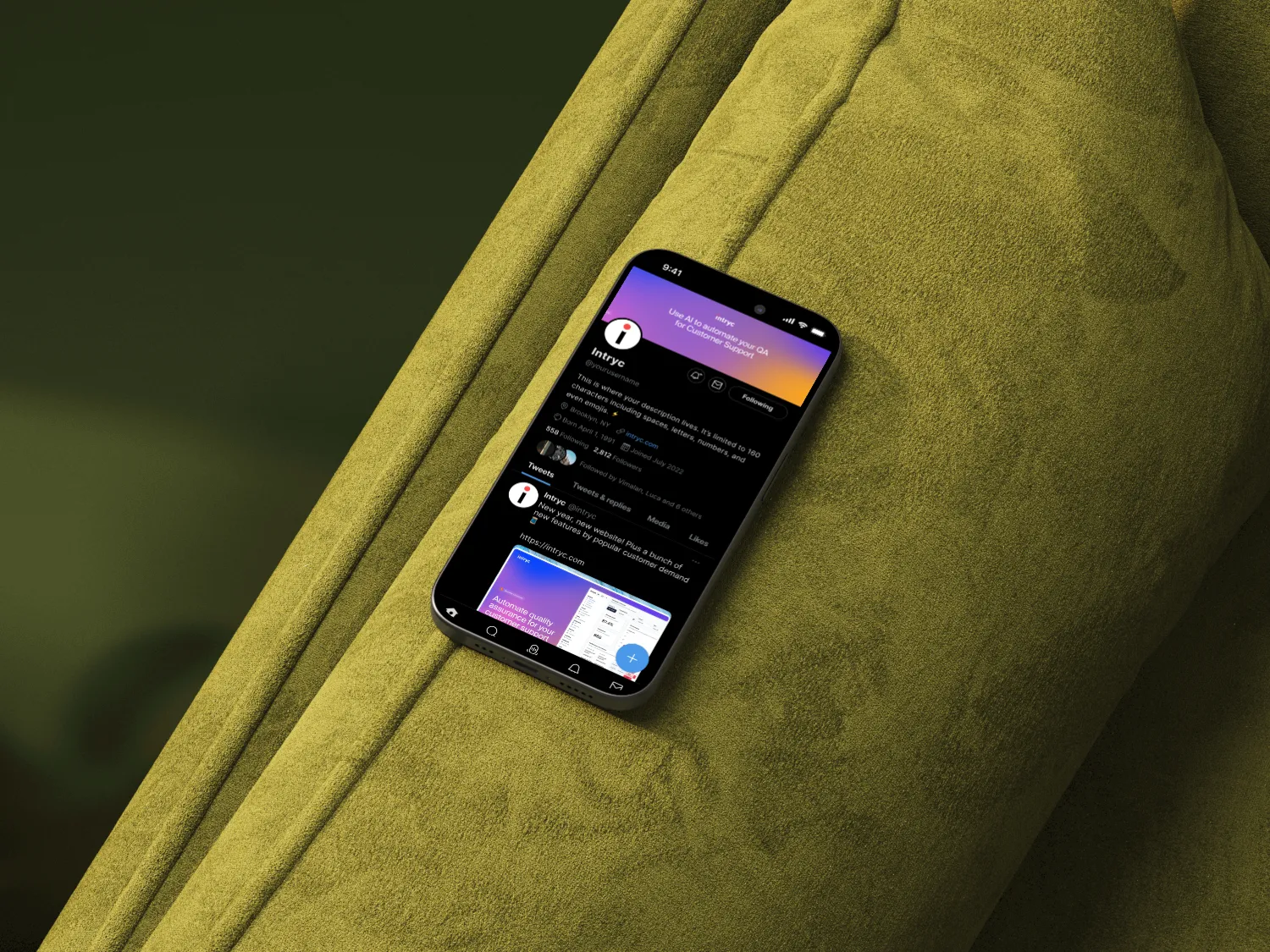 iPhone 15 Pro displaying a Twitter profile with a dark mode interface on a green textured fabric surface.