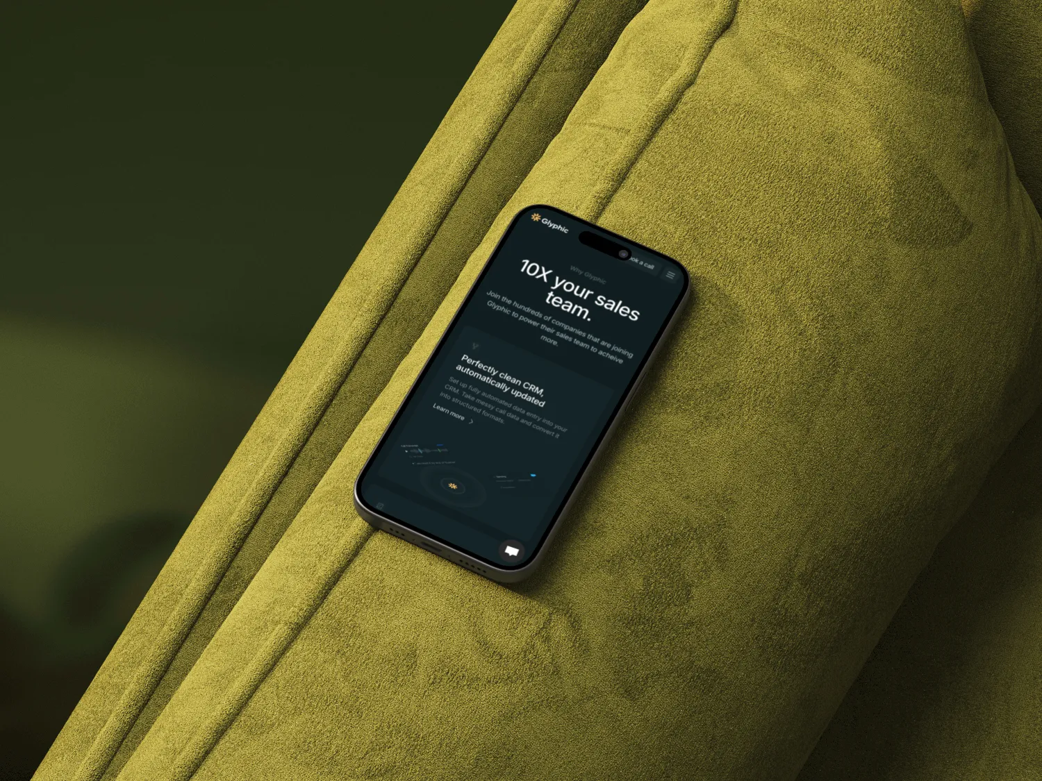 Smartphone displaying a sales team CRM app screen on an olive green textured cushion.