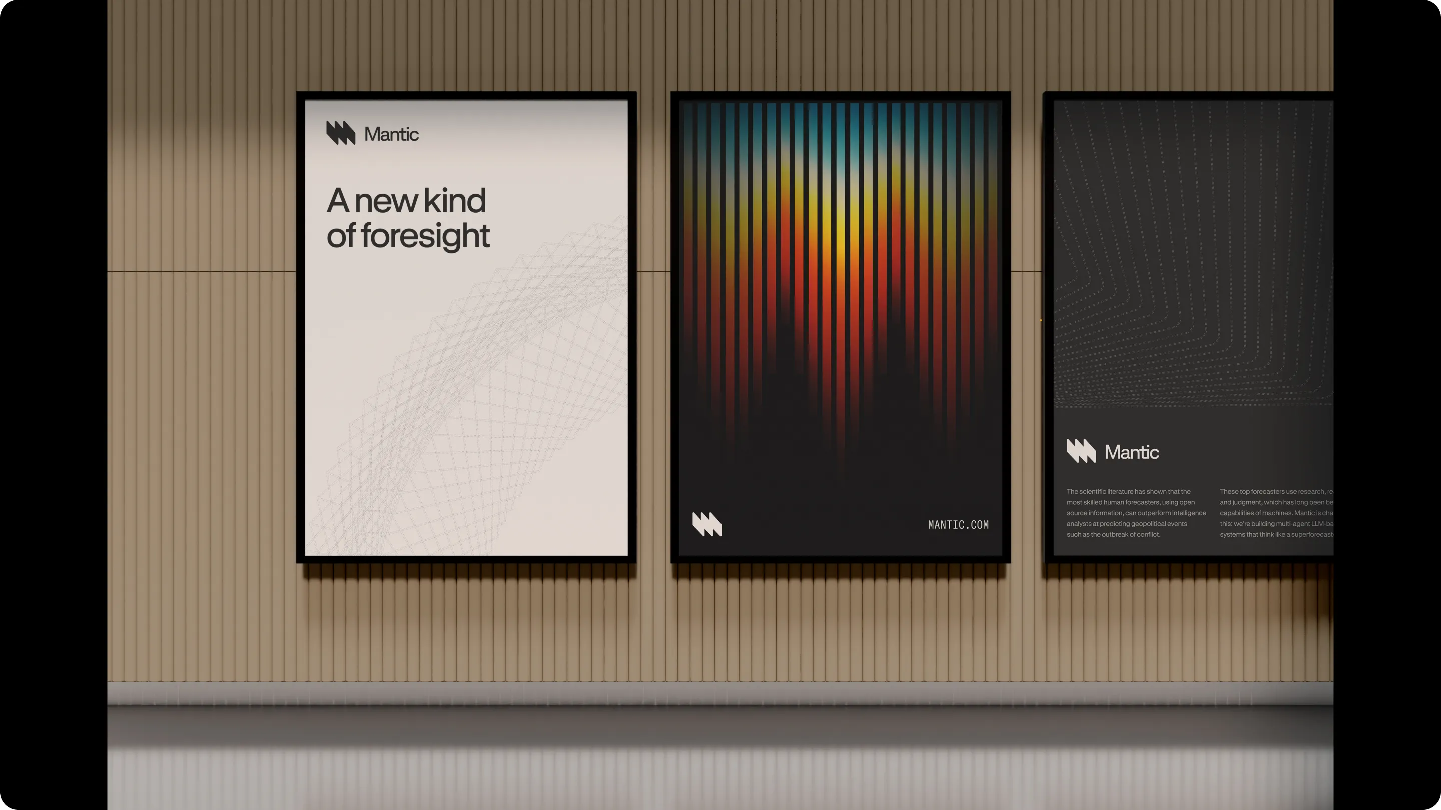 Three framed posters on a wooden wall, featuring Mantic branding and themes of foresight and forecasting.