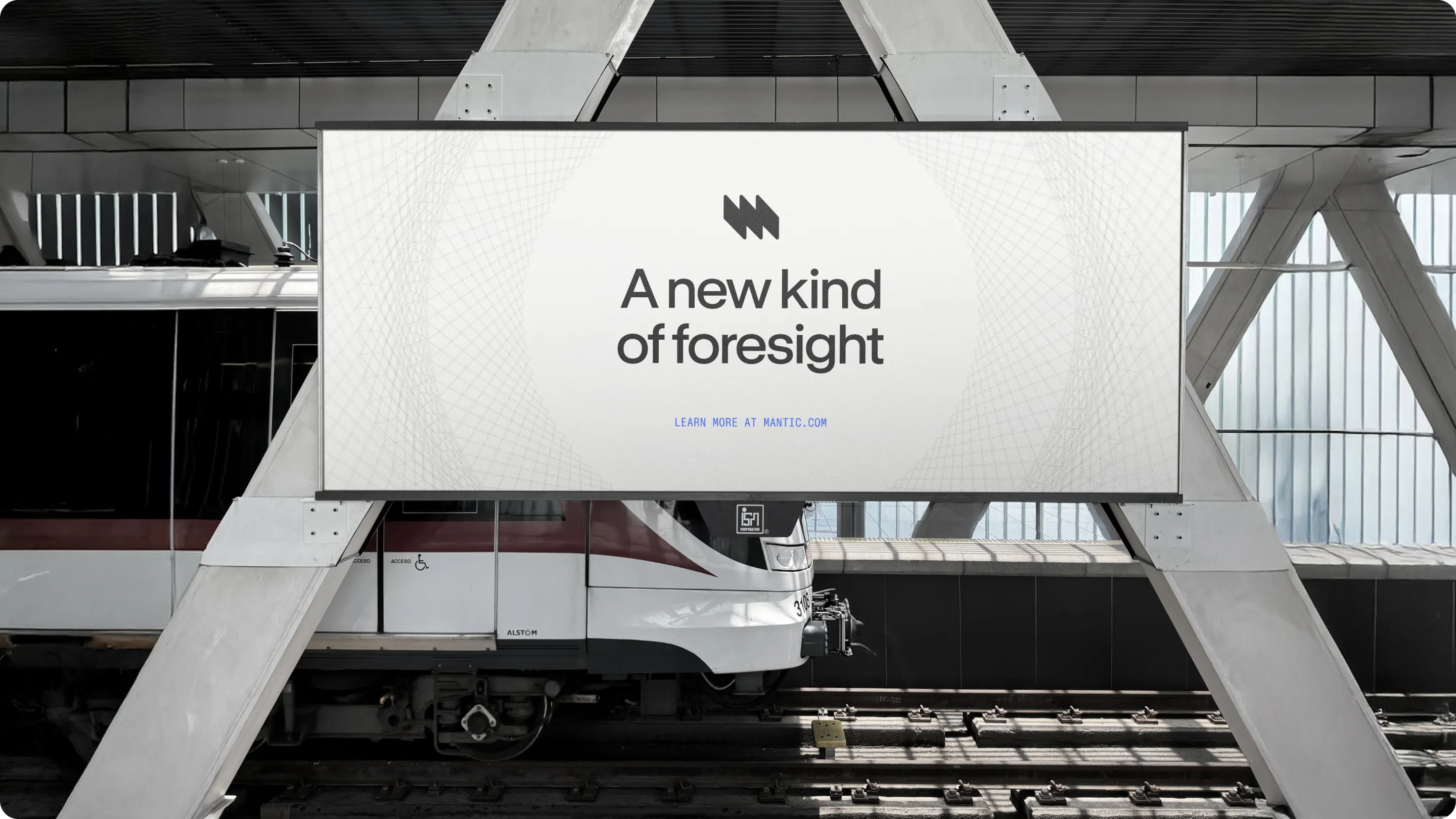 Train at a station platform with a large advertisement banner reading 'A new kind of foresight' and 'Learn more at mantic.com'.