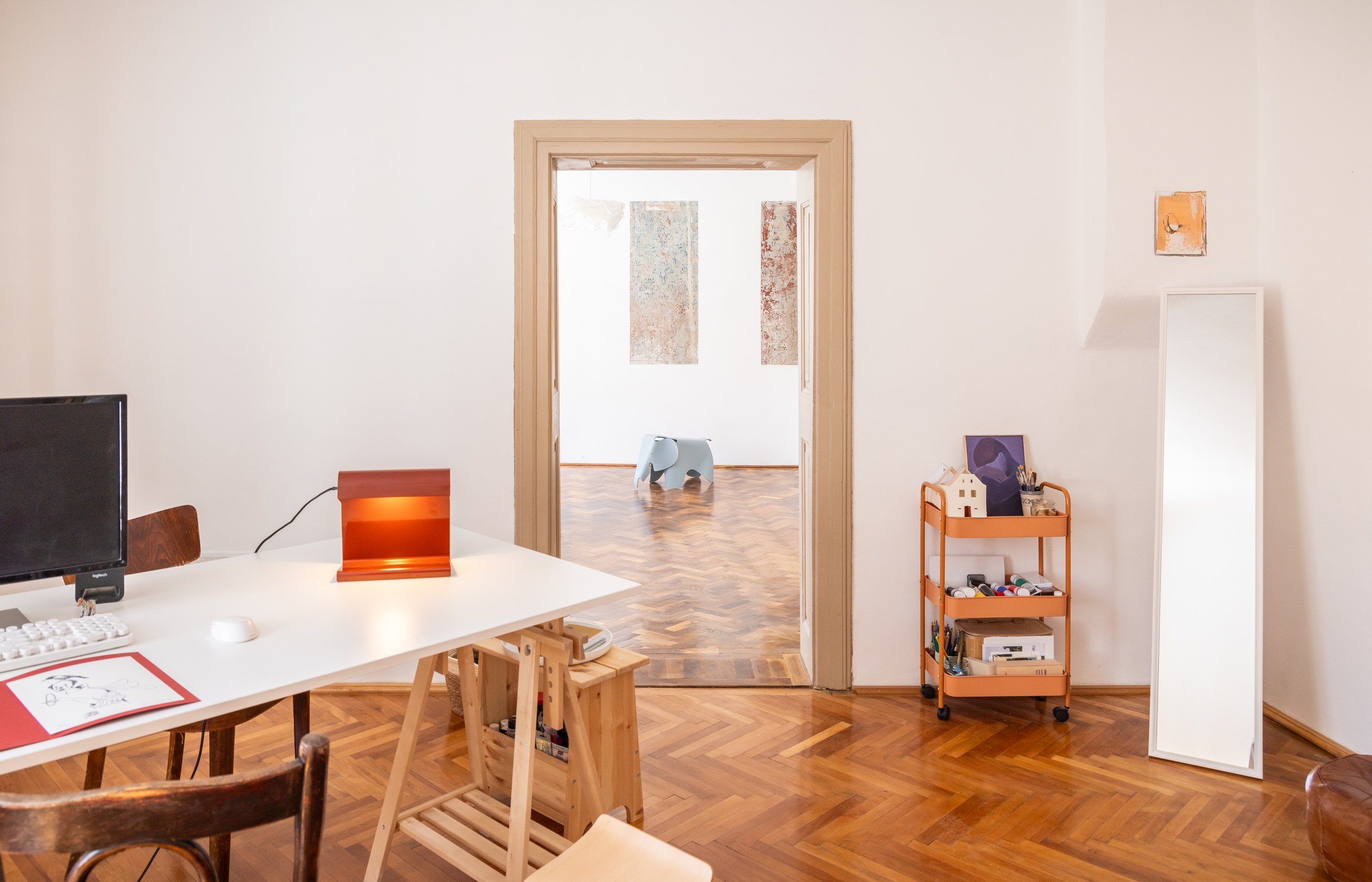 Apartment workspace with shelving and a view through the doorway