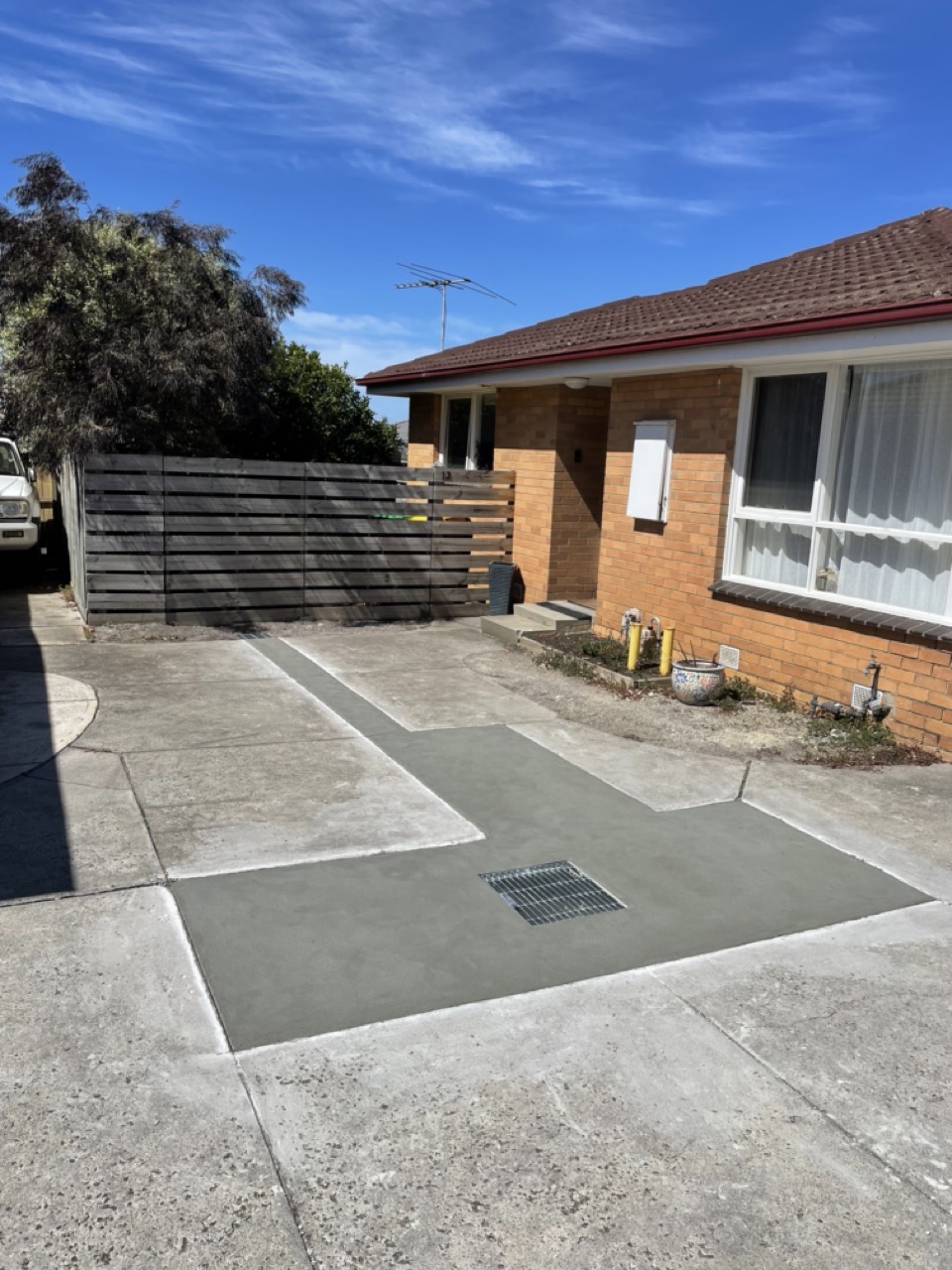 Finished driveway drainage grate installation