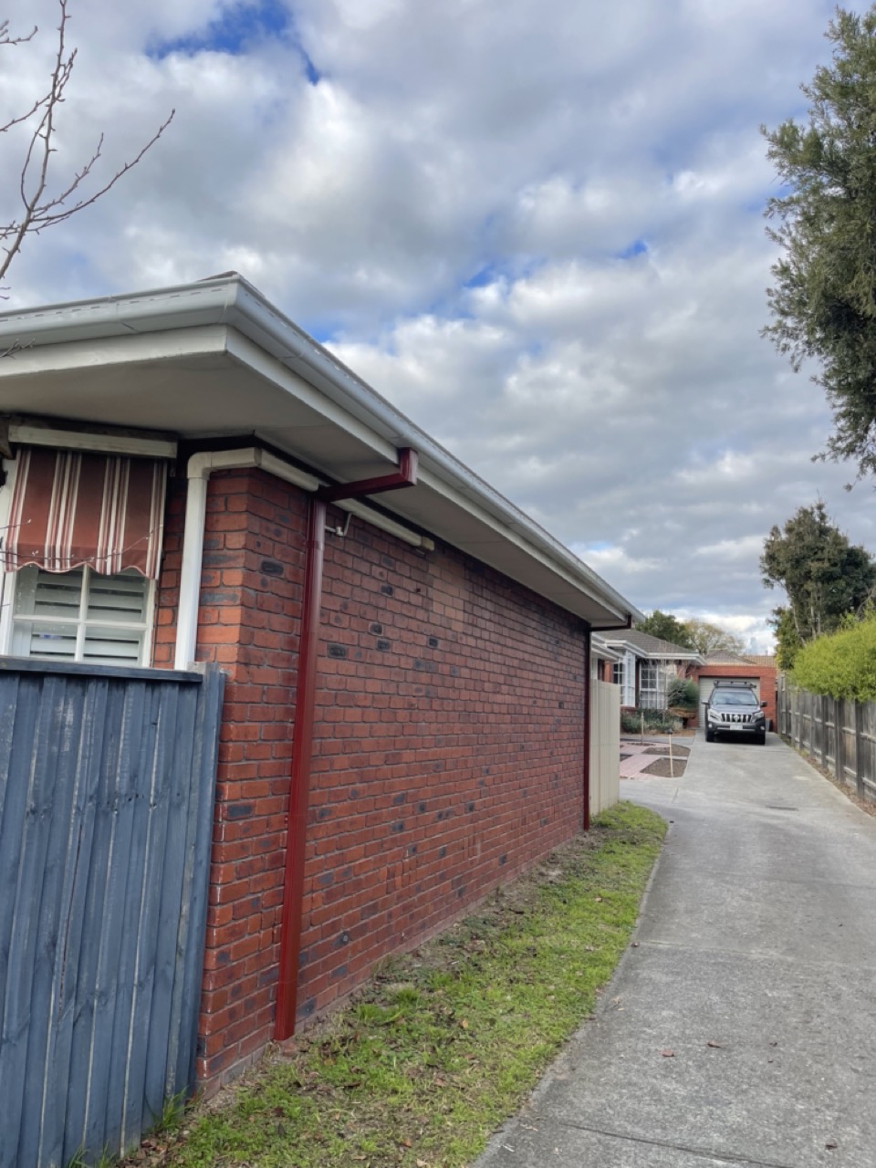Downpipe and guttering installation on brick home
