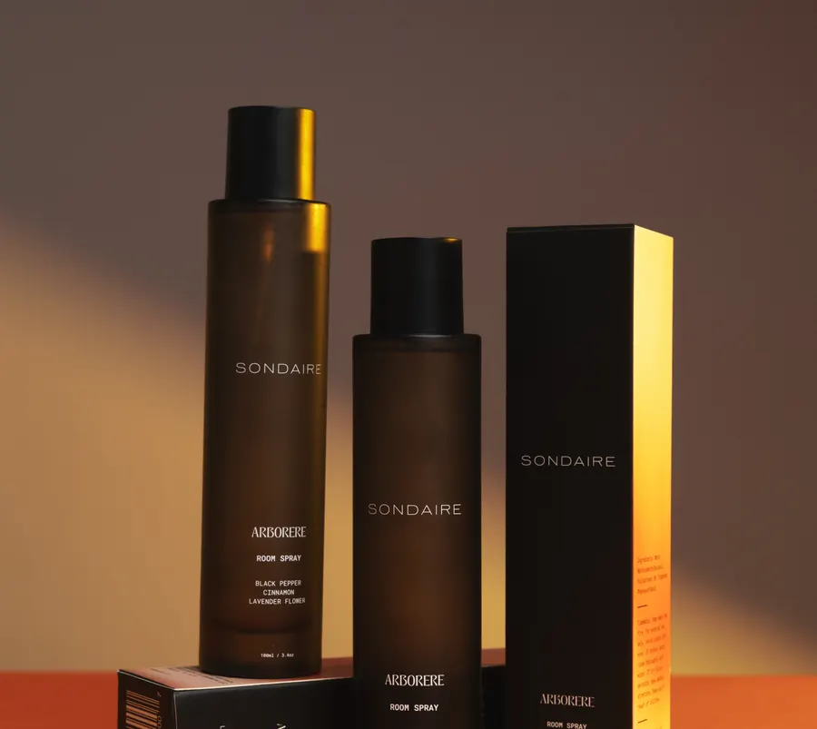 Sondaire room spray bottles beside their boxes
