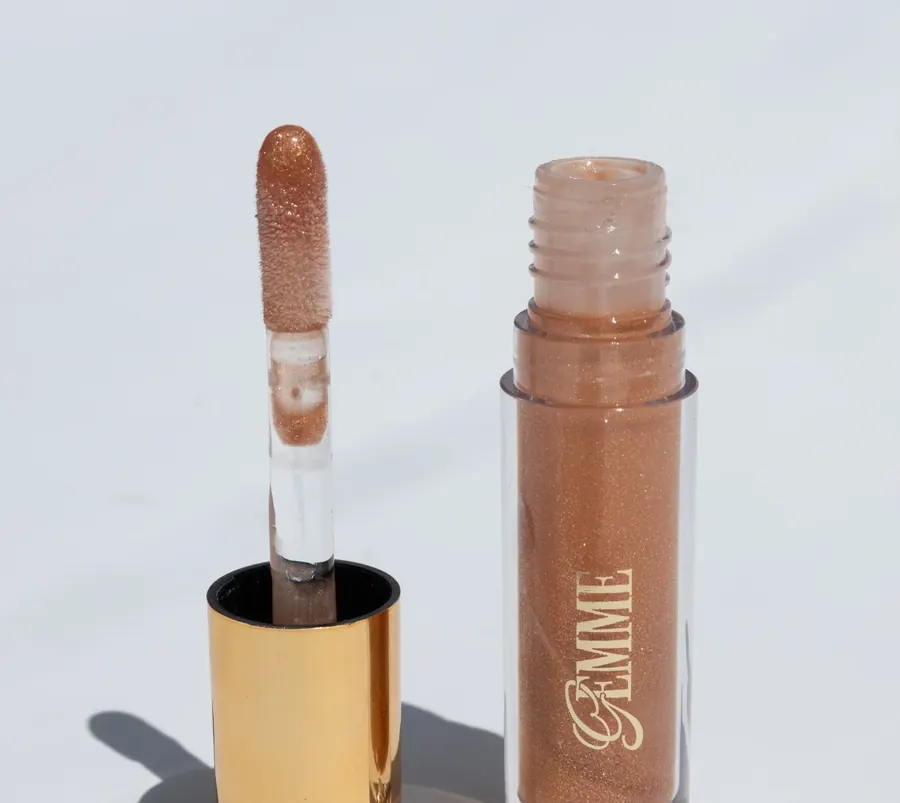 An open Gemme lip gloss tube with its wand