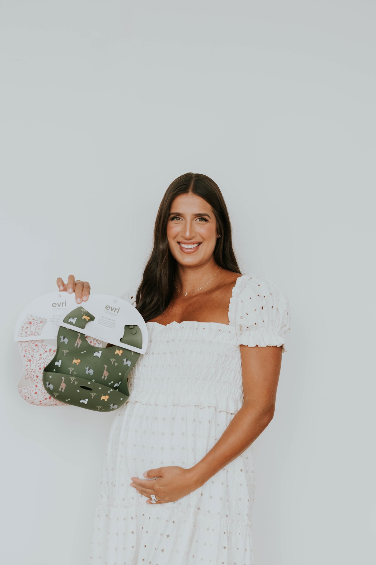 An expectant founder holding her own silicone baby bibs