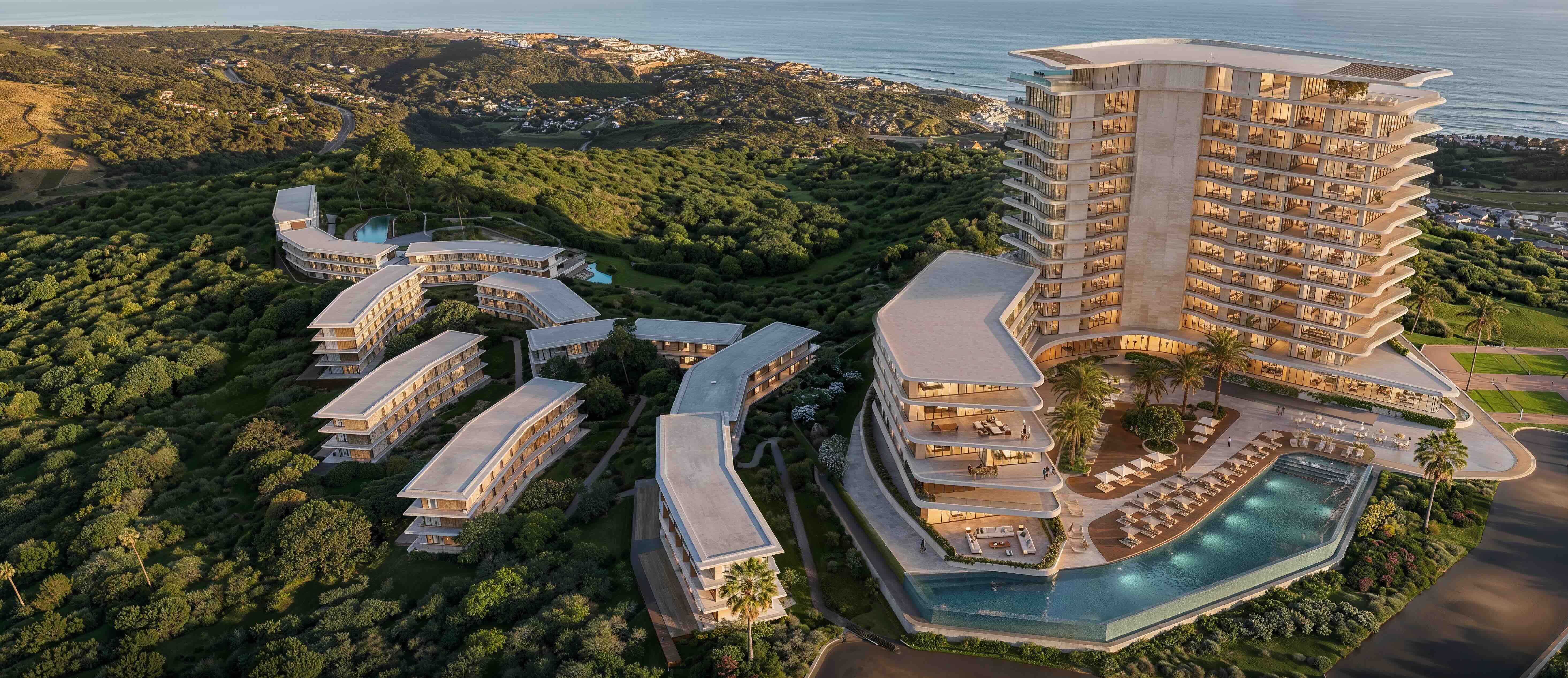 Modern multi-level resort complex with curved buildings featuring glass walls and terraces, surrounded by green hills and palm trees at sunset, with outdoor pools and lounge areas.