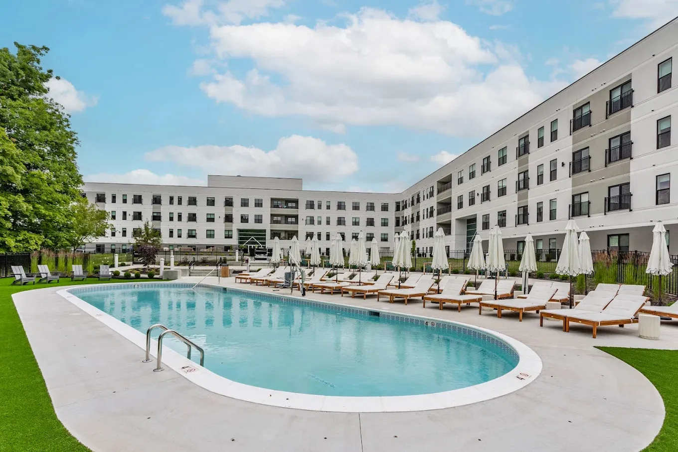 The Altura apartments pool terrace with lounge seating and finished turf