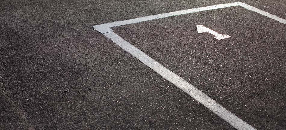 Fresh white parking-space lines on dark asphalt