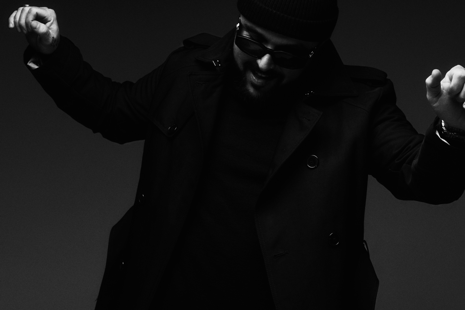 FERREIRA in a black coat and sunglasses