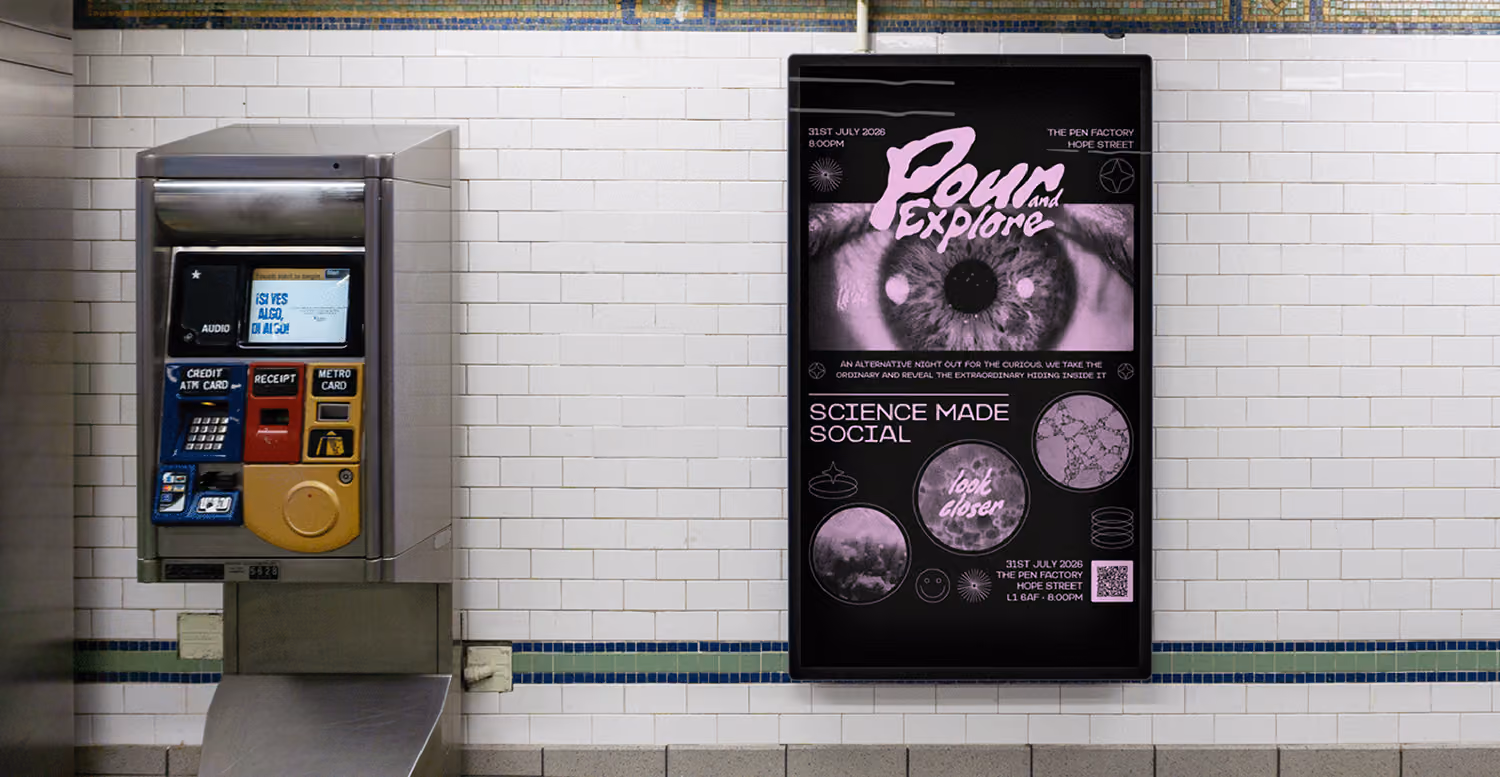 Subway station wall with a silver ticket machine on the left and a black digital poster on the right showing an eye with the text 'Pour and Explore' and 'Science Made Social' in pink and white.