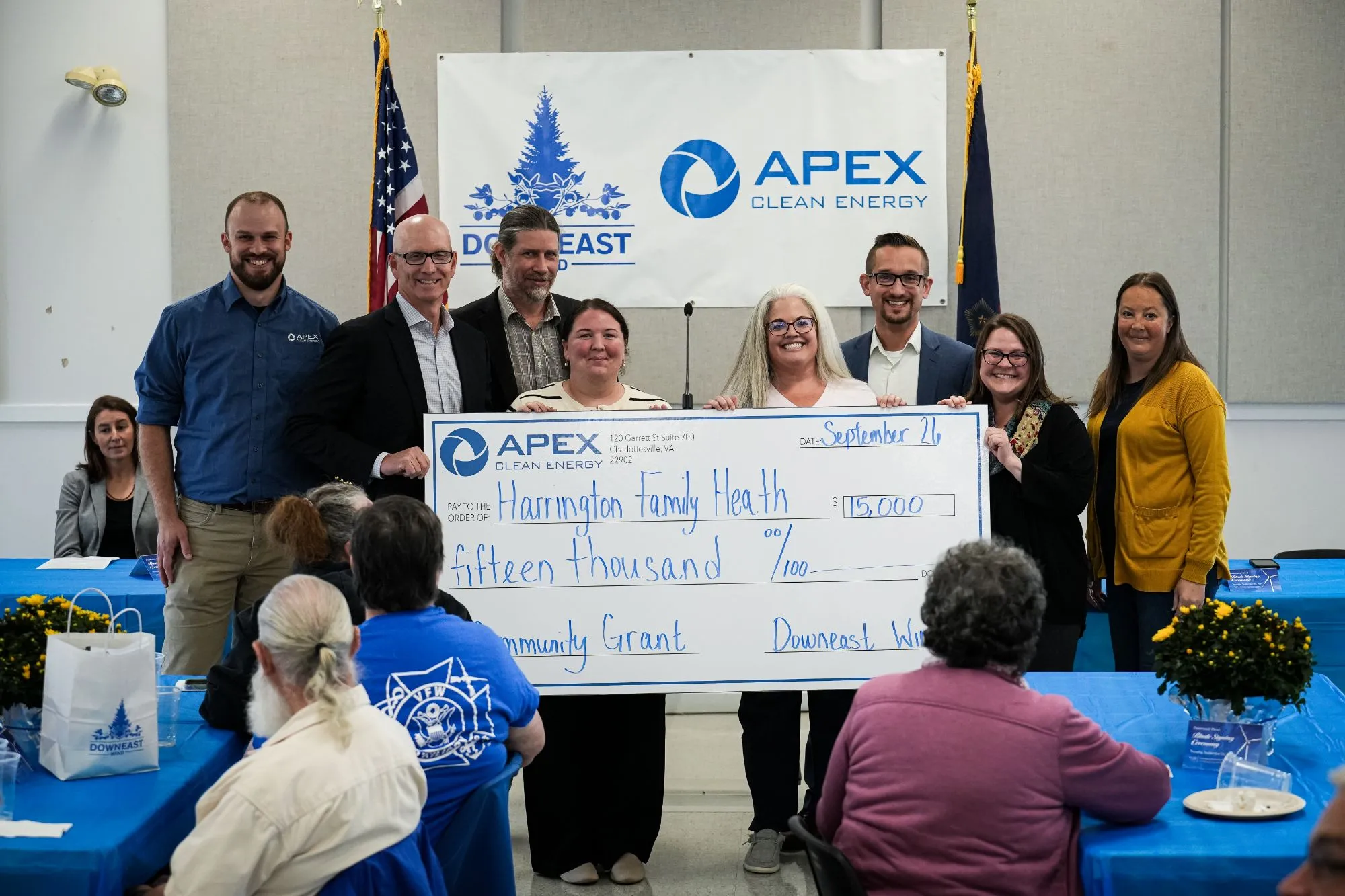 Group holding large $15,000 check from Apex Clean Energy dated September 21 for Harrington Family Health.