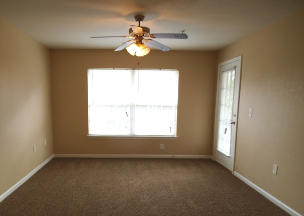 Empty room with window and ceiling fan
