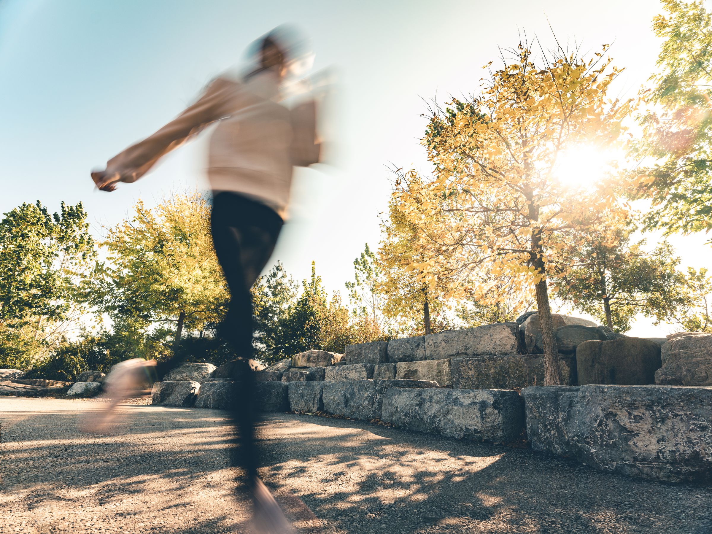 A figure moving through warm light, motion blurred