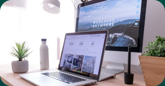 Laptop and desktop monitor set up on an office desk