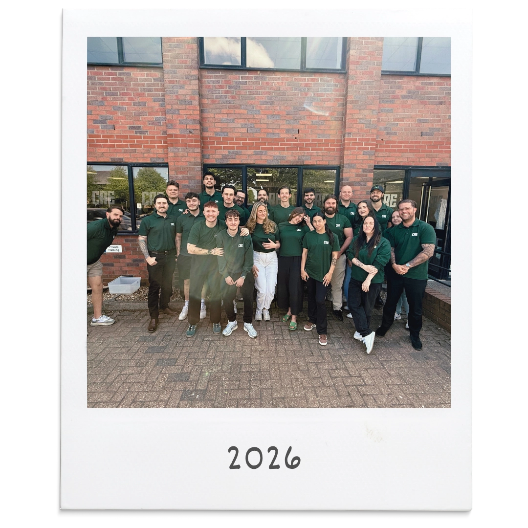 The CRE team in green branded tops outside the office in 2026