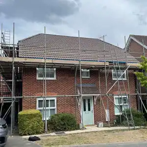 Residential house roof showing repaired tiles and structure