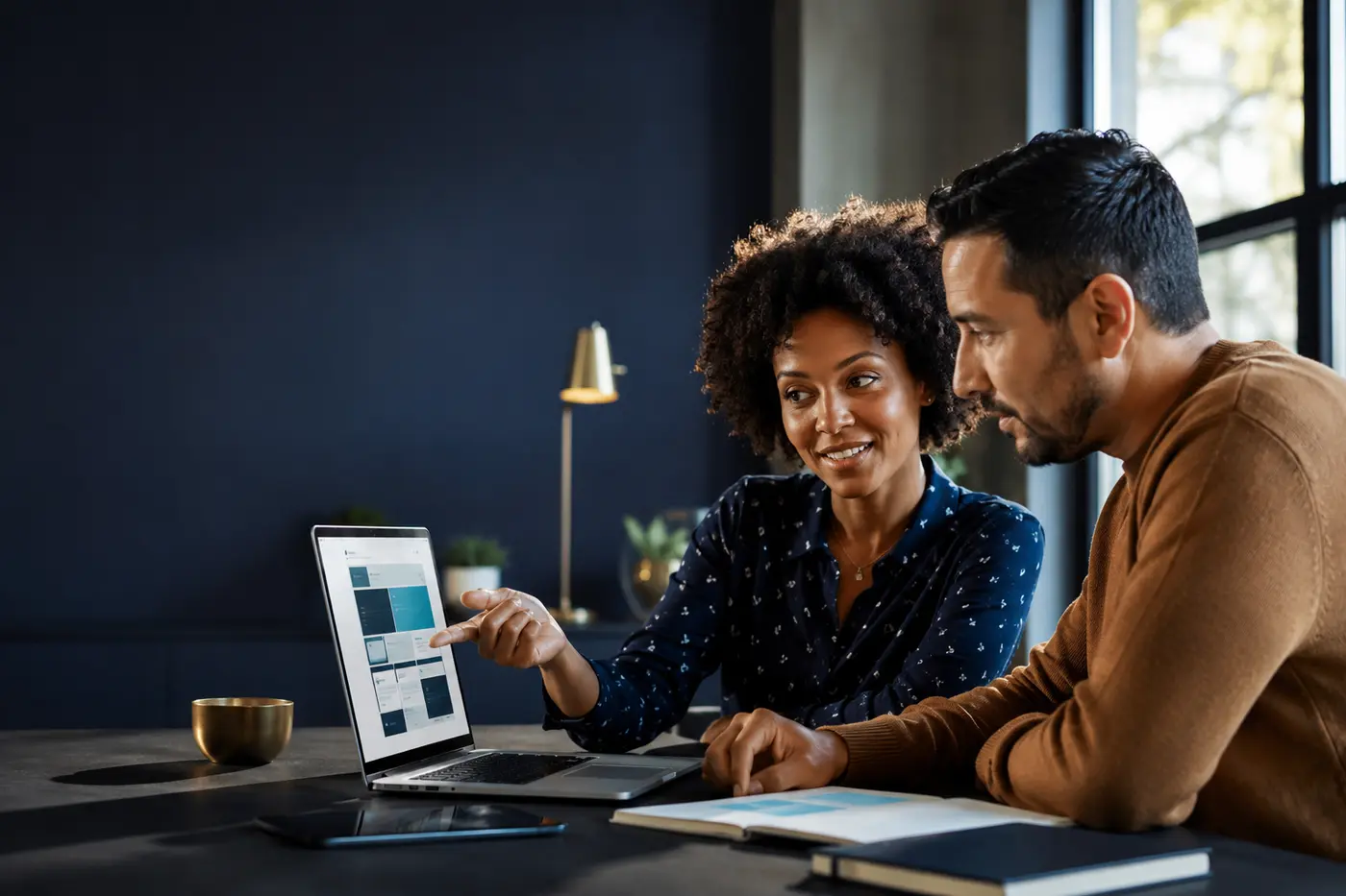 Small-business owner and website strategist reviewing a responsive website plan