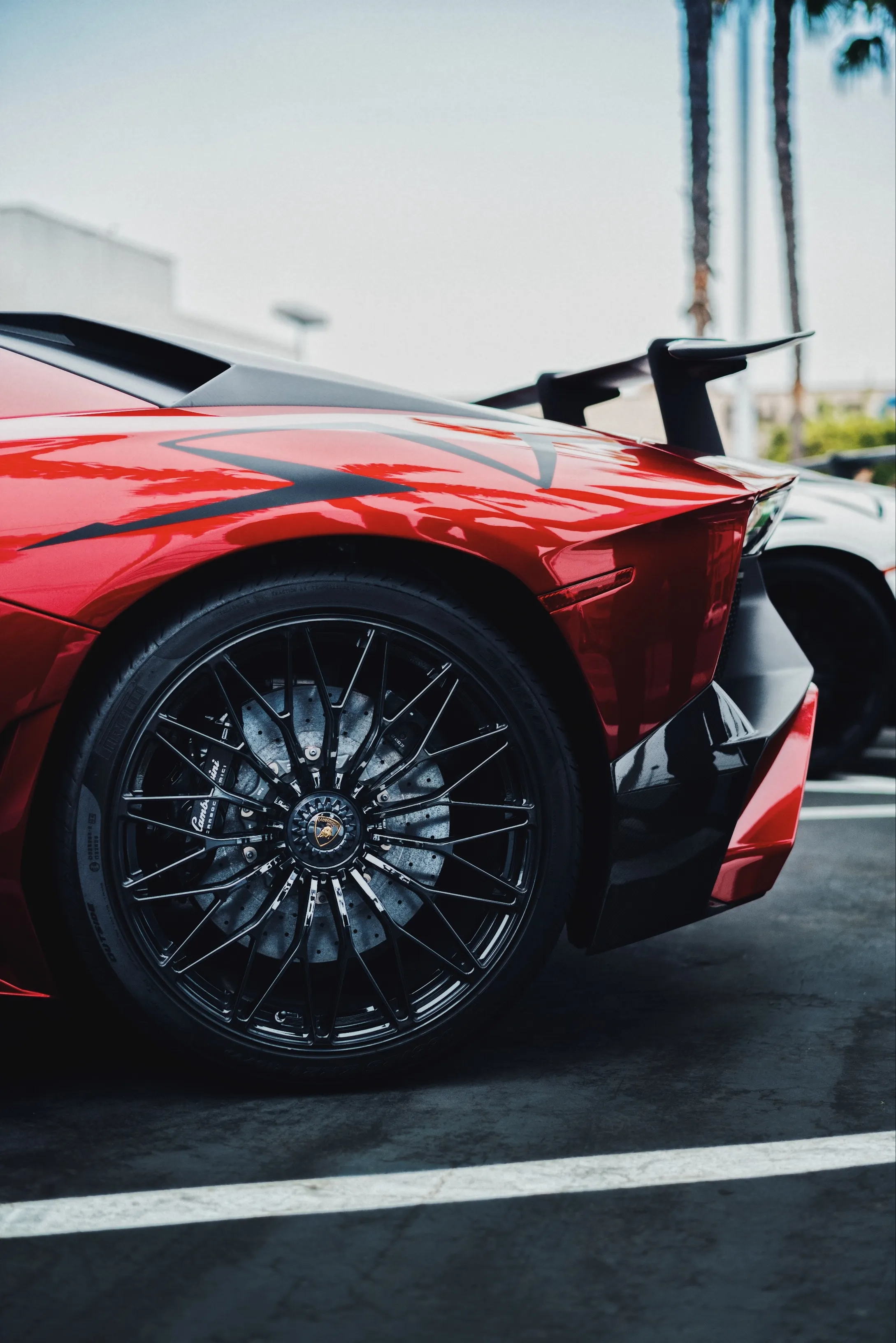 Red sports car with black multi-spoke wheels