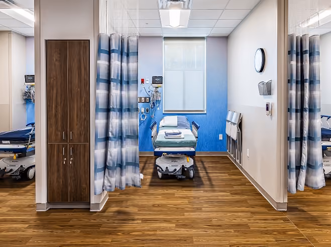 Procedure bay with a patient gurney and privacy curtains at Northeast Digestive's endoscopy suite.