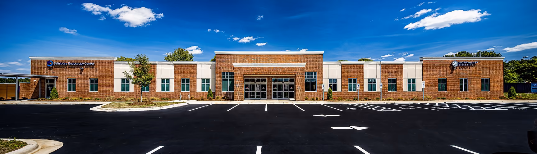 Exterior of a Northeast Digestive gastroenterology office building with a landscaped parking lot.